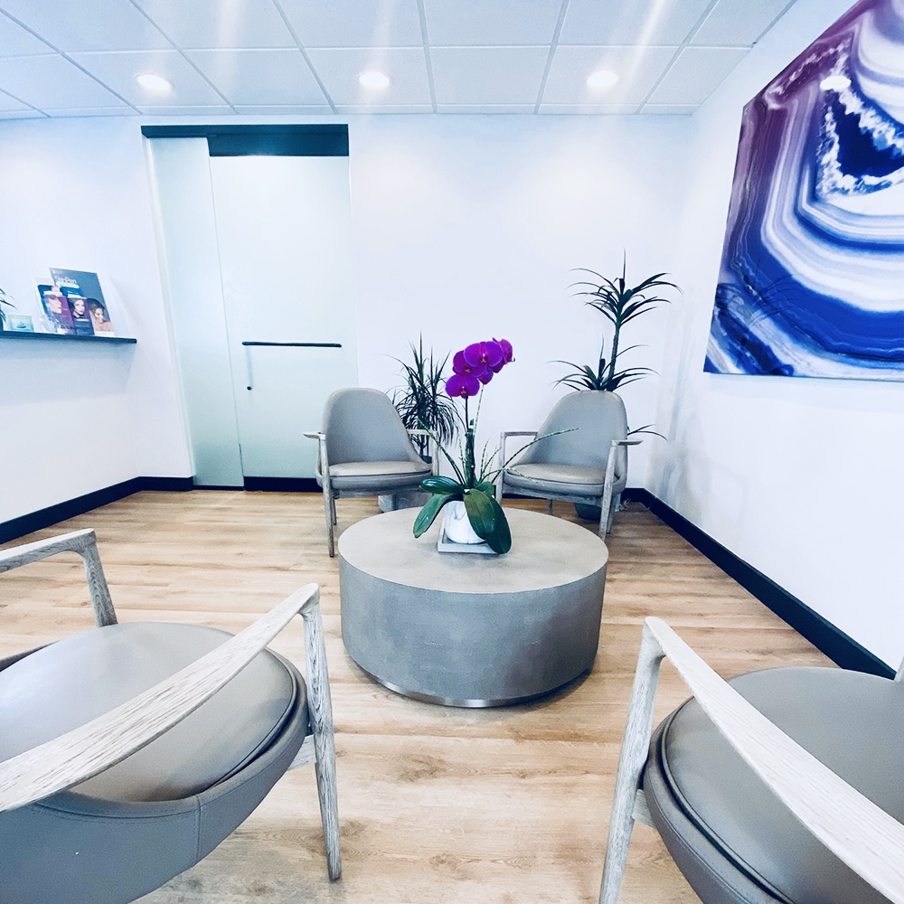 An image of the Bloom Health waiting room with purple accent colors in Bloomfield Hills, MI.